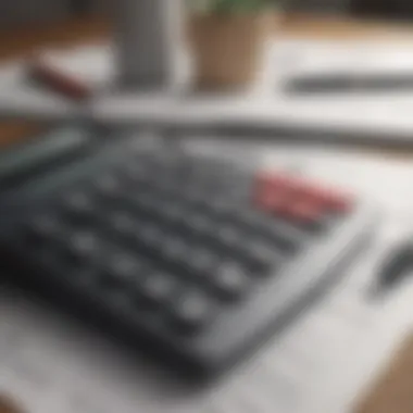 A calculator and financial documents on a desk.