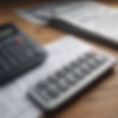 Close-up of a calculator and financial statements on a wooden table.